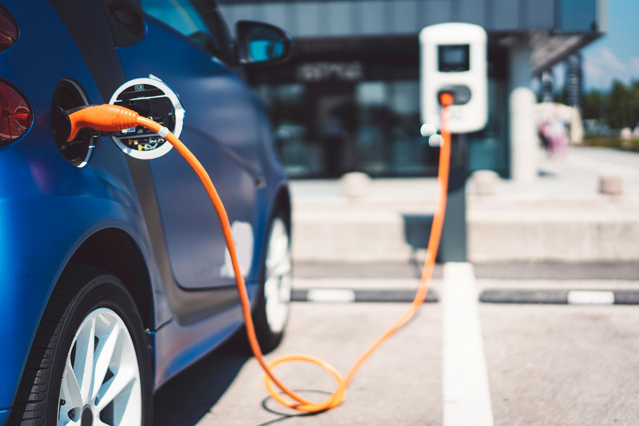 What is the history of the development of pure electric vehicles?