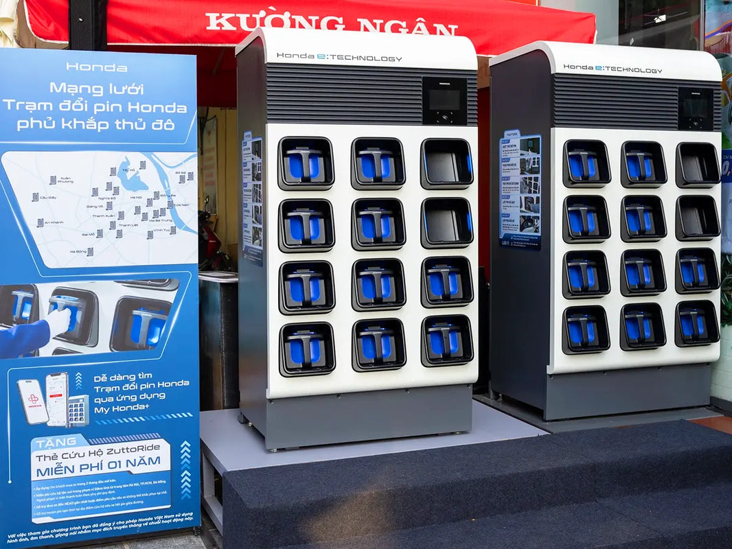 Honda e:Swap battery swapping station with two 12-slot cabinets and network map display in Hanoi, Vietnam