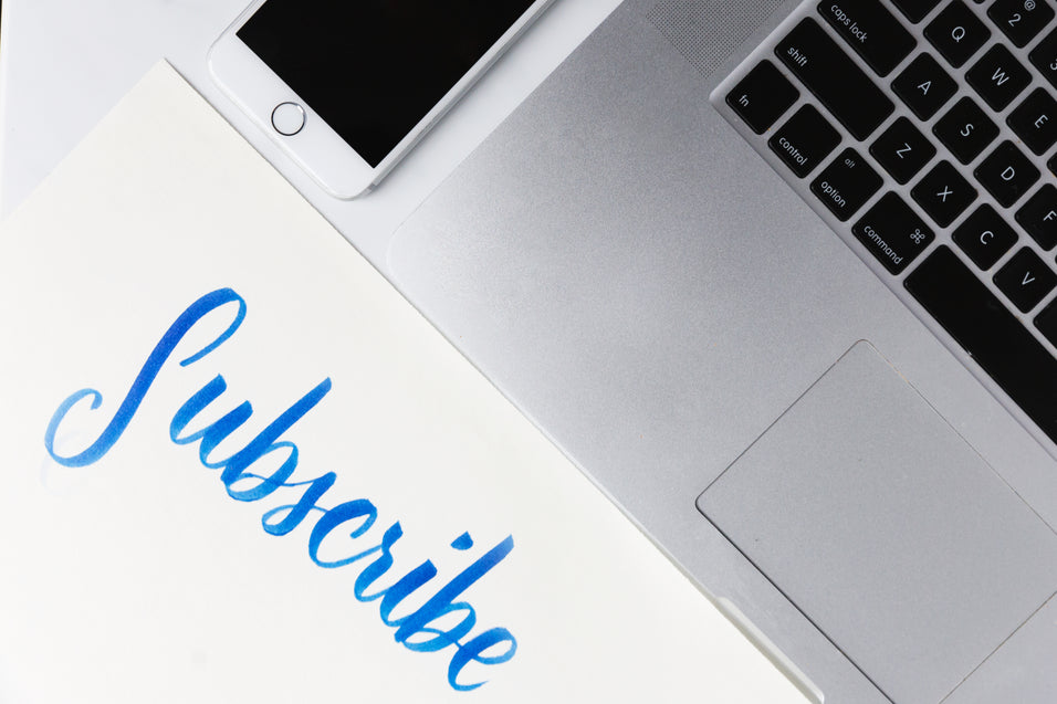 office-desk-with-piece-of-paper-urging-you-to-subscribe